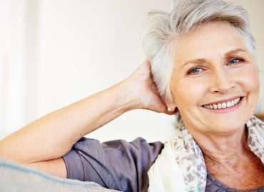 Smiling senior woman relaxing at home